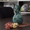 کوزه سفالی مشبک پتینه با طرح سر بز در چیدمان